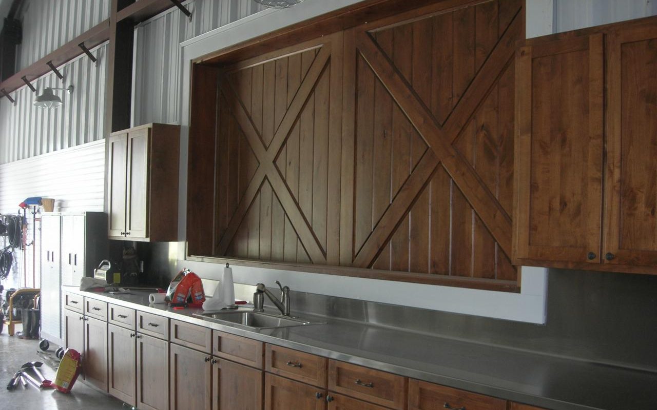 Kitchen counter and cedar barn door inside a barndominium shop, built by Cross Creek