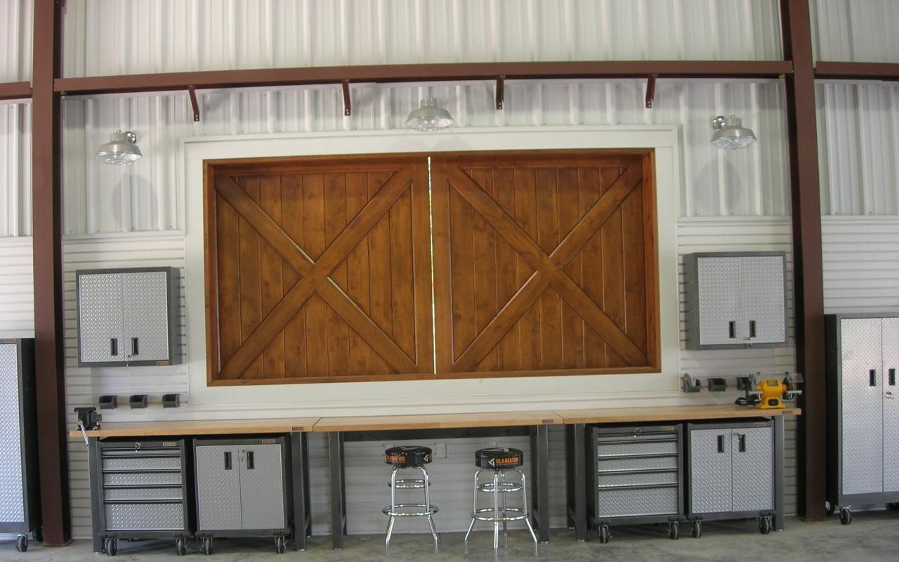 Barndominium shop with a long workbench and cedar barn door, built by Cross Creek