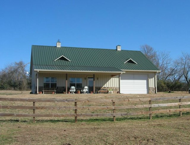Barndominium porch with limestone columns in the morning sun