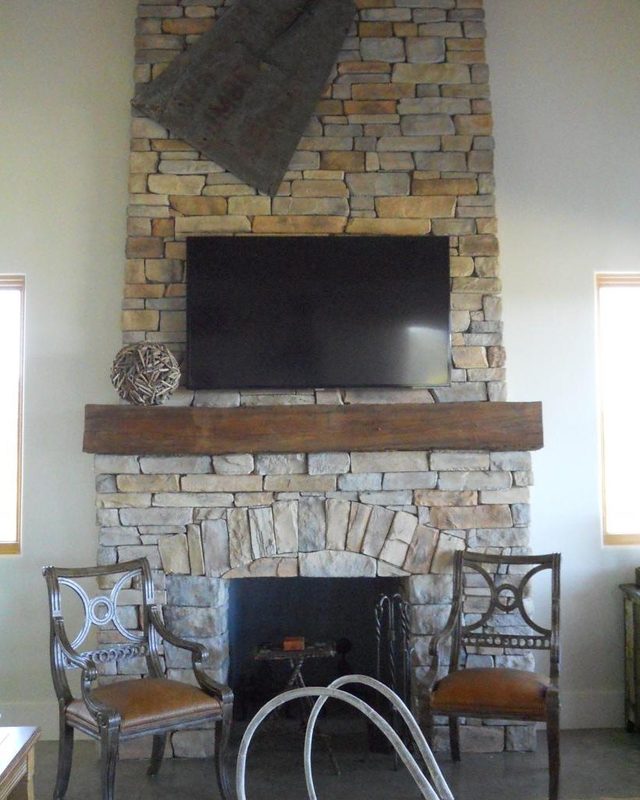 Floor-to-ceiling stone fireplace inside a guest casita