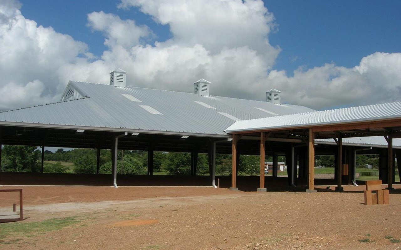 Covered riding arena with a walkway from the stable, built by Cross Creek