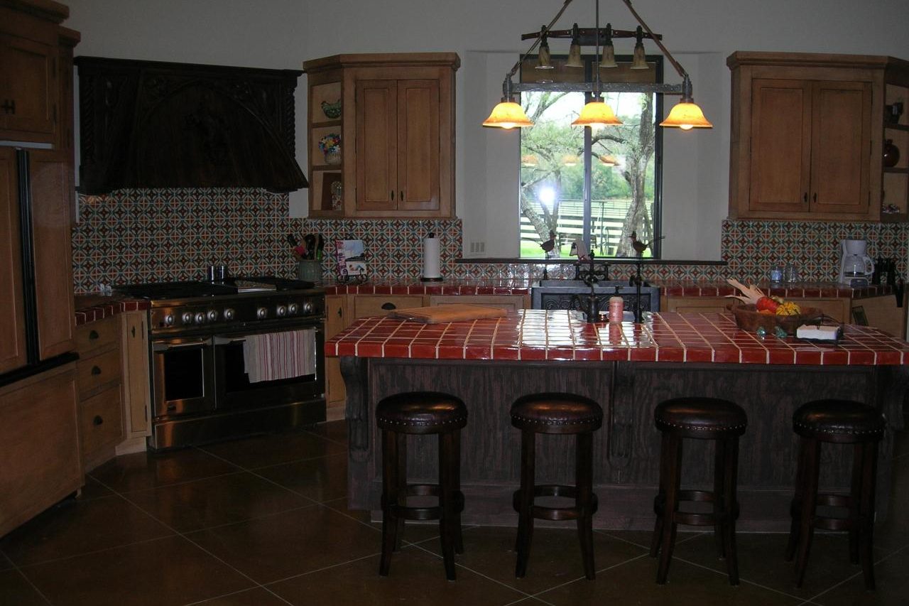 Custom kitchen with tile island and stained concrete floors