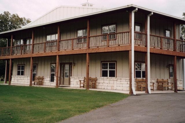 Two-story equipment building with office and full-length porch