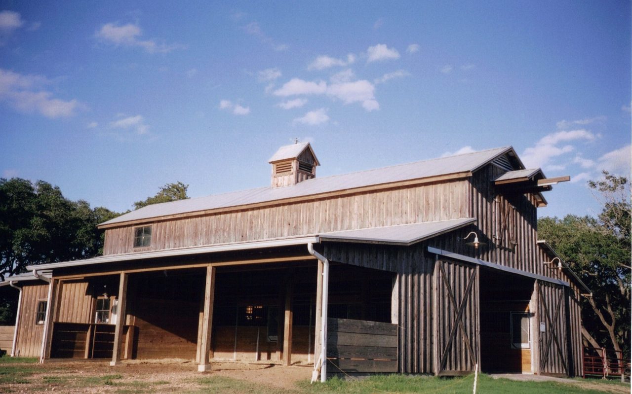 Custom horse barn with cupolas built by Cross Creek