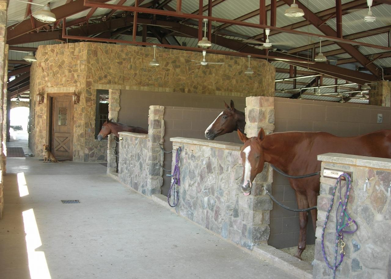 Stone-column horse stalls inside the Polo Barn